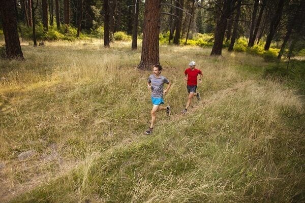 Jeff Browning, 44, in hat, red, and Ryan Ness, 40, enjoy a Sunday morning run on the trails in Bend's Shevling Park.