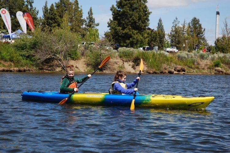 Family kayaking adventure on the Deschutes River in Bend, Oregon.