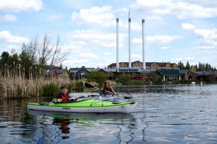 Family kayaking adventure on the Deschutes River in Bend's Old Mill District.
