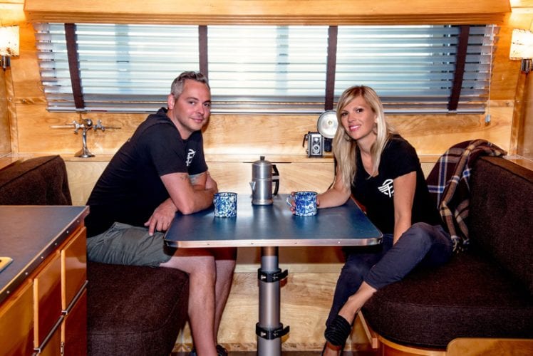 Justin and Anna Scribner inside the Flyte Camp Neutron vintage-inspired camping trailer.