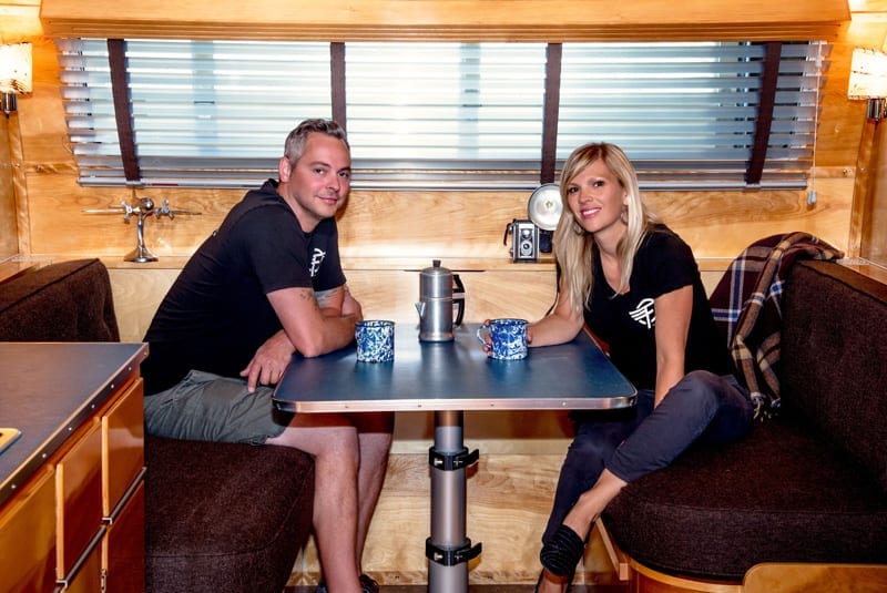 Justin and Anna Scribner sit in the Neutron, Flyte Camp's new model of vintage-inspired camping trailers.