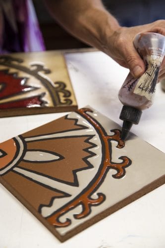 Justyn Livingston of Metolius Ridge Tile hand glazes tile in her Bend, Oregon studio.
