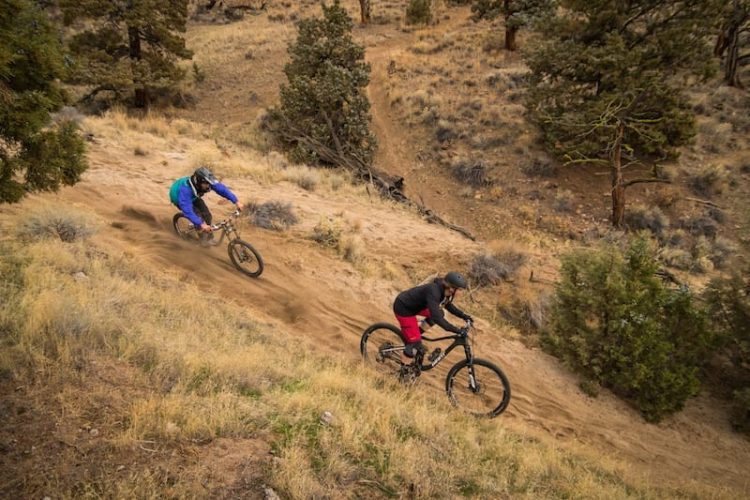 Couple mountain biking in Bend on dirt trail