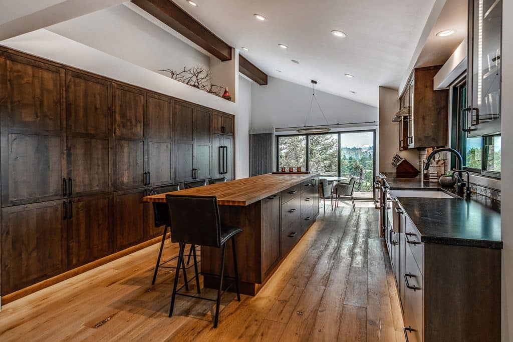 Long kitchen island with rustic decor.