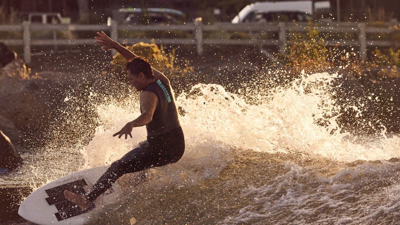 A surfer catches a wave at Bend Whitewater Park