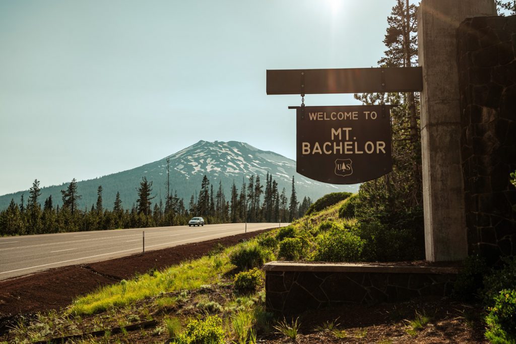 Mt. Bachelor sign and road with Mt. Bachelor in the background