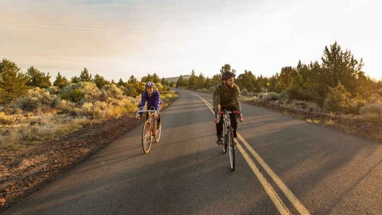 Couple biking on a road in Central Oregon