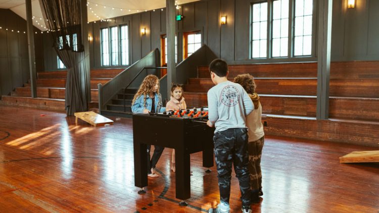 Kids playing foosball in the gym at the Society Hotel Bingen