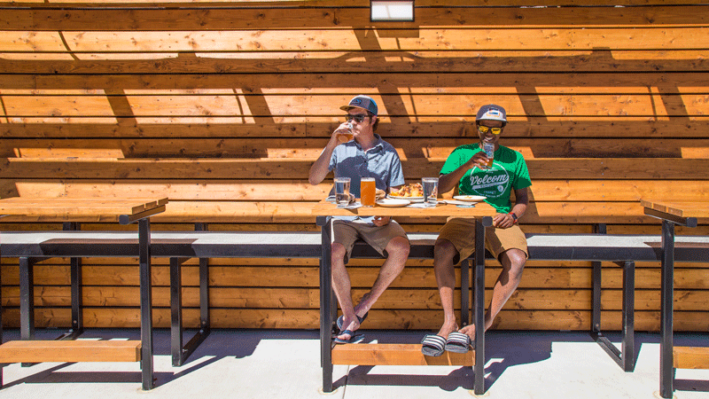 Two men enjoying beer and food at Bend Brewing Co