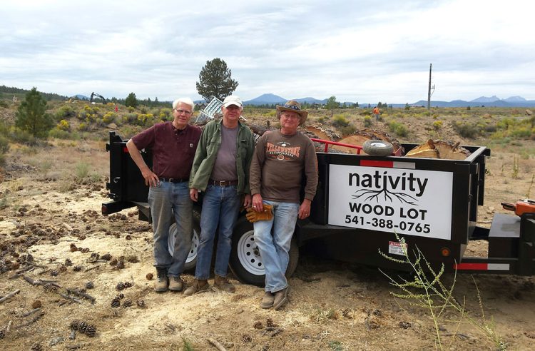 Volunteers standing in front of the Nativity Wood Lot Truck and Trailer