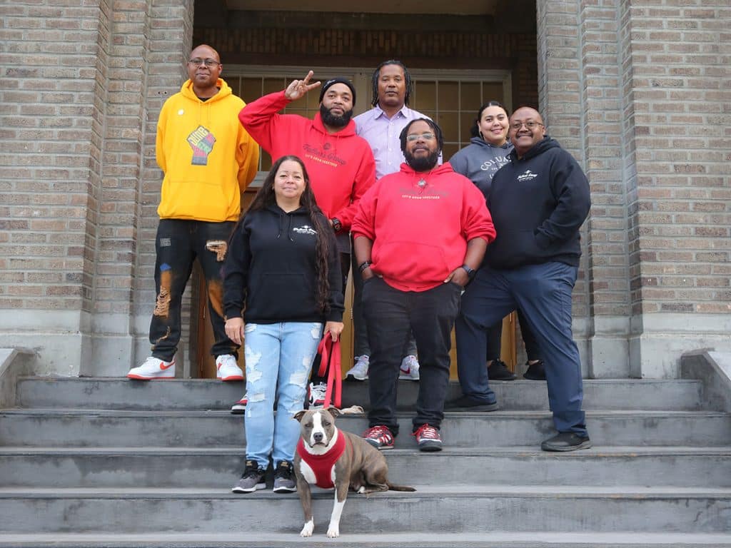 The Fathers Group's Ujima team on the front steps