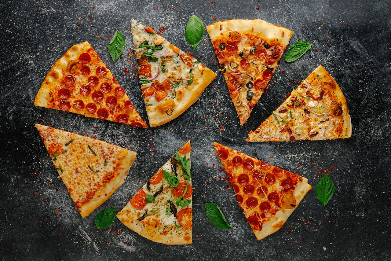 Pizza Mundo pizza slices spread out on counter