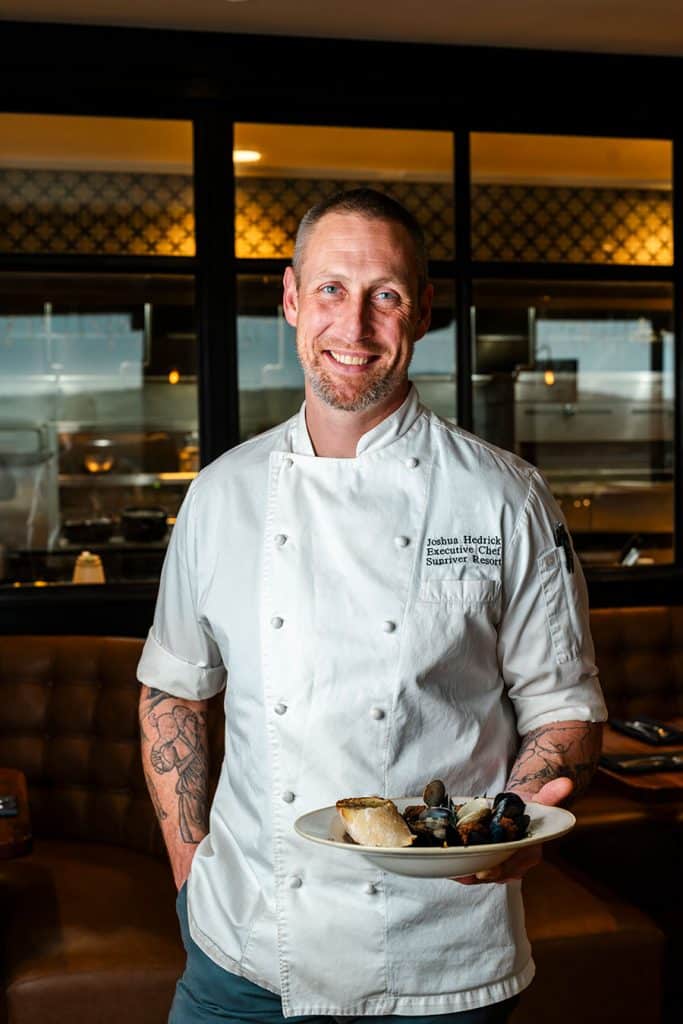 Chef of Lodge Kitchen with plate of food