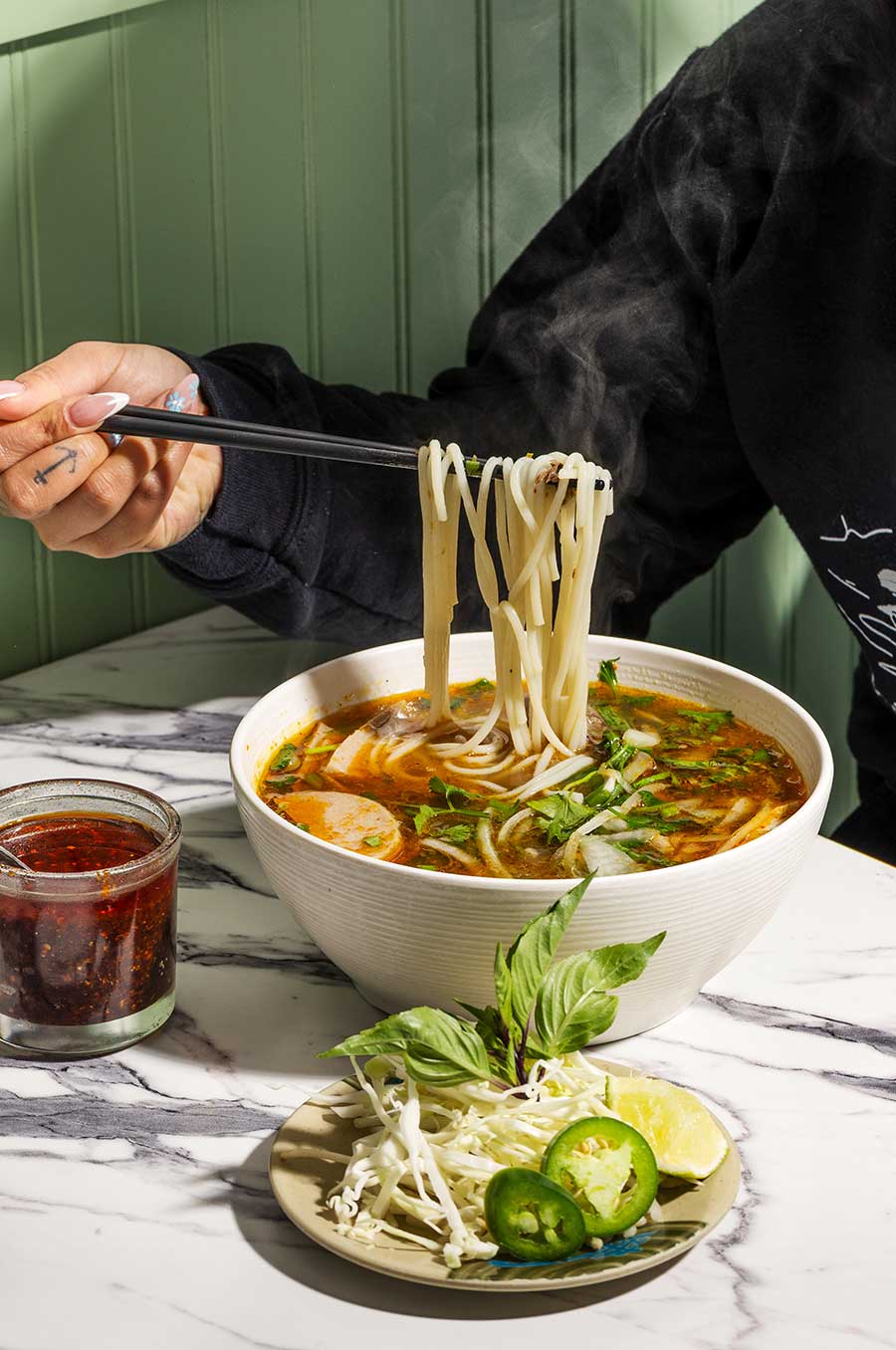 Pho Viet Pho in bowl being eaten with chopsticks