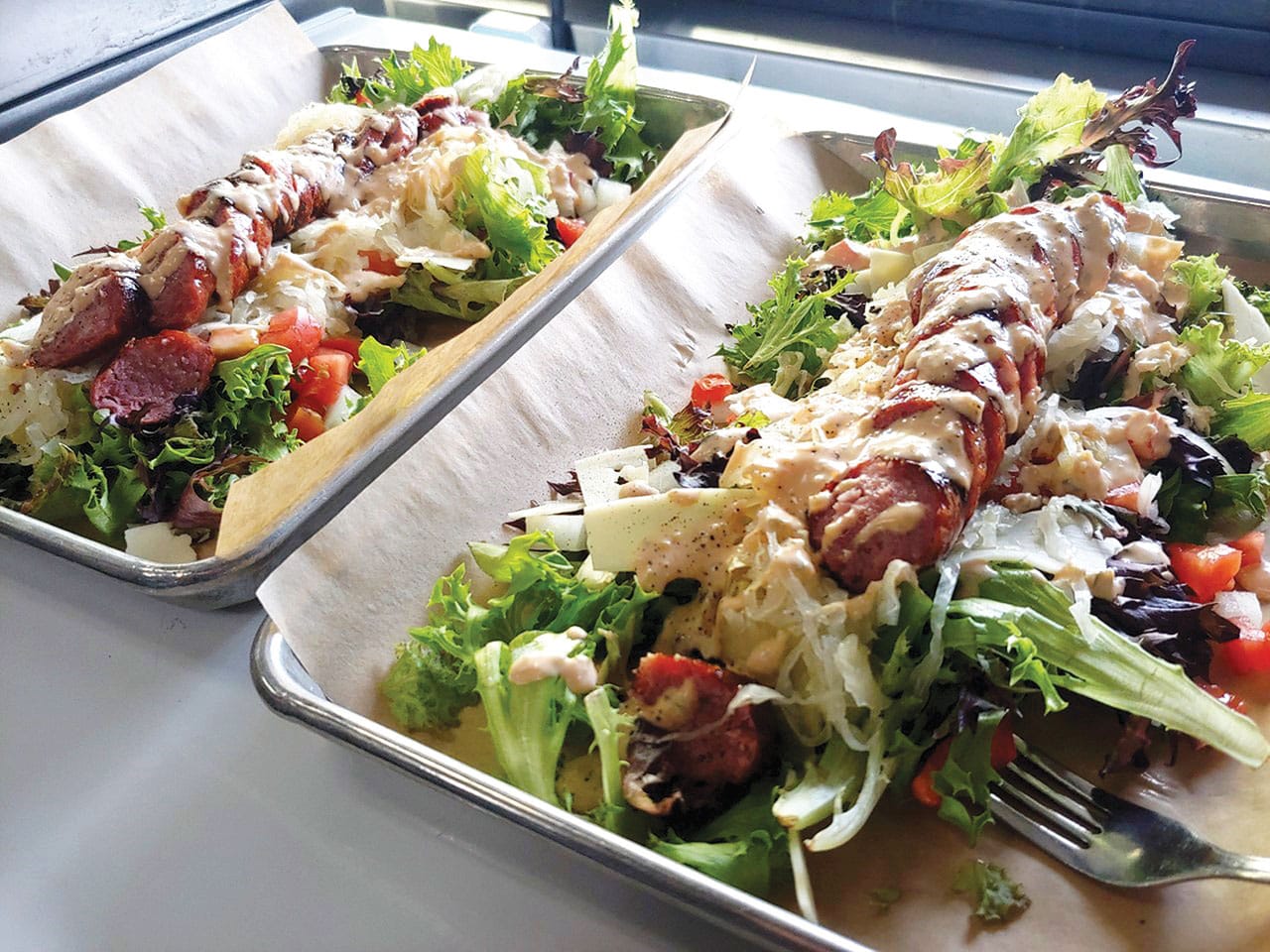 Salad with sausage in a to go box