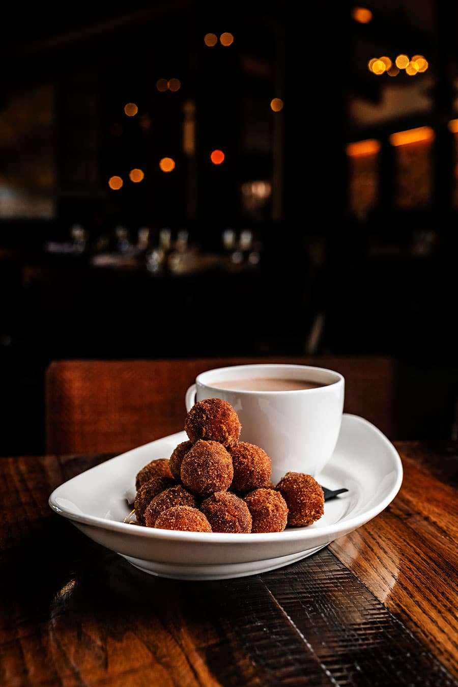 Coffee and treats on a plate.