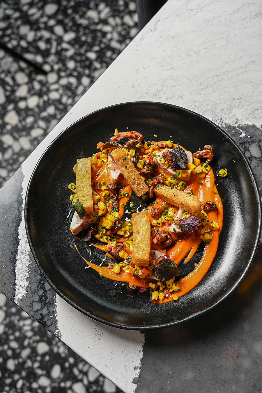 Lady Bird entree dish in black bowl on countertop