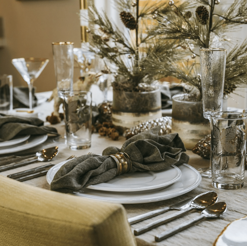 Table setting with decorative napkin and pine branches