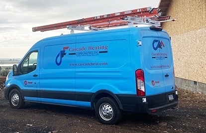Bright blue van with red latter on top next house under construction