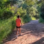 Woman taking workday walk on trail