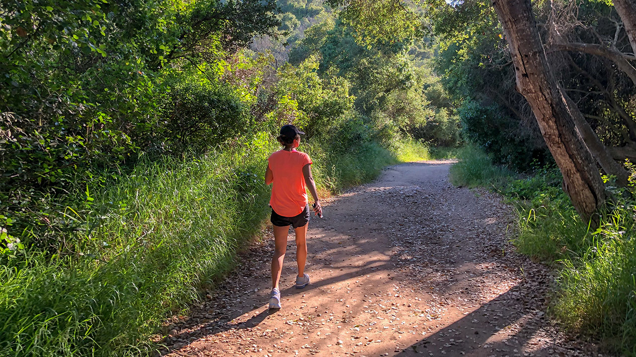 Woman taking workday walk on trail
