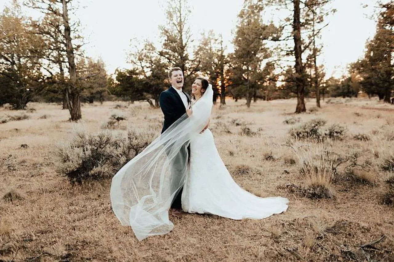 Bride and groom in field