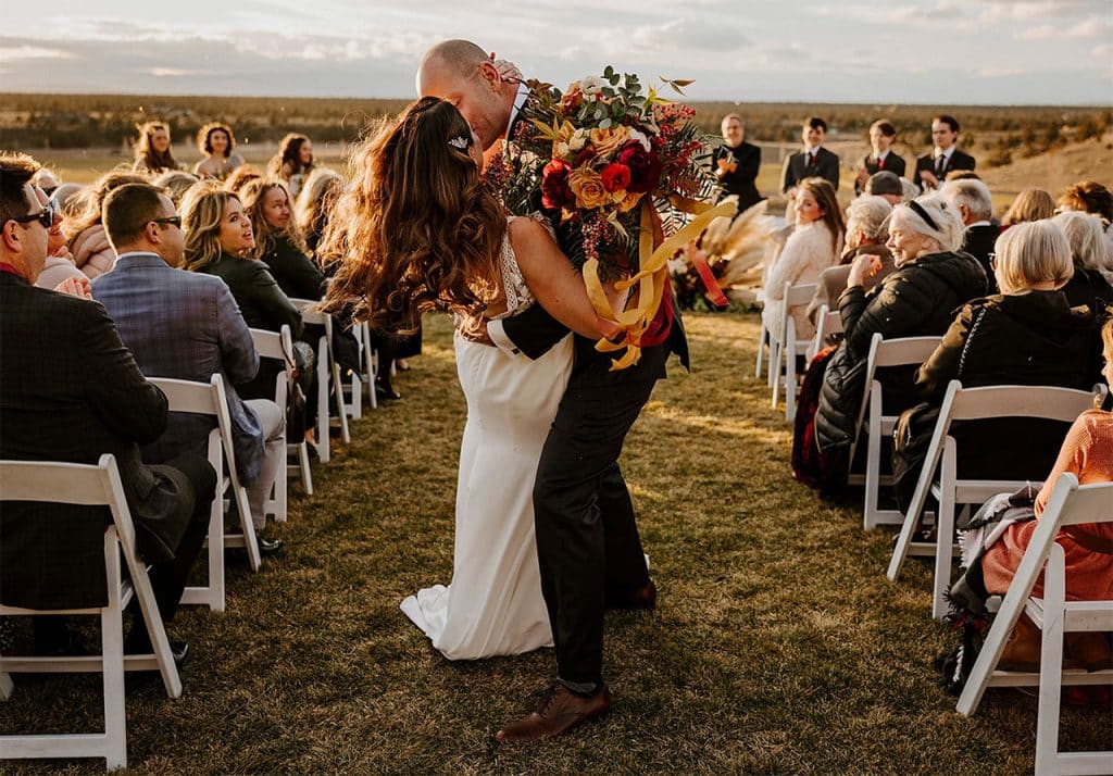 Couple kissing on the aisle.