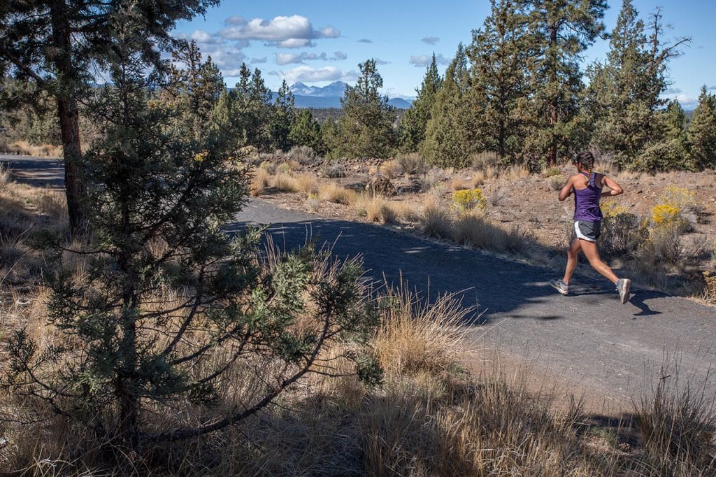 Woman running Awbrey Reach portion of the Deschutes River Trail