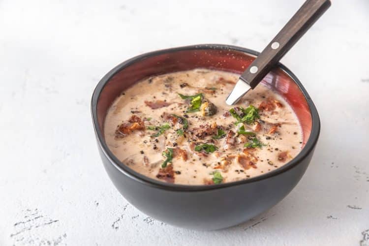 a bowl of clam chowder with bacon