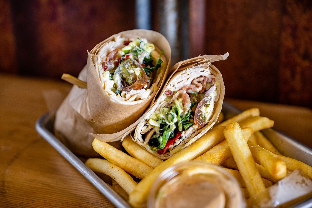 Wrap and fries on a tray from Luckey's Woodsman.
