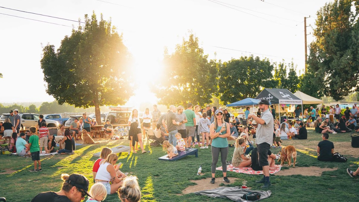 Crowd on the lawn at sunset at Crux Brewery in Bend
