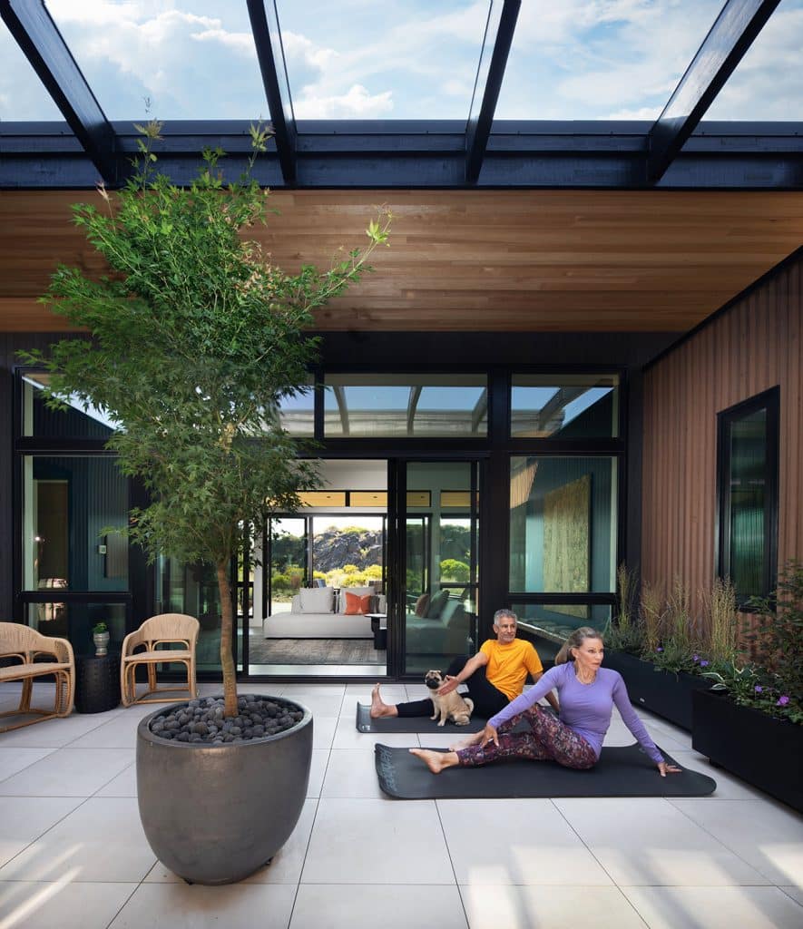Owners do yoga in front of their Shevlin Commons home