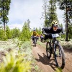 Ladies AllRide flying down a dirt trail in Bend