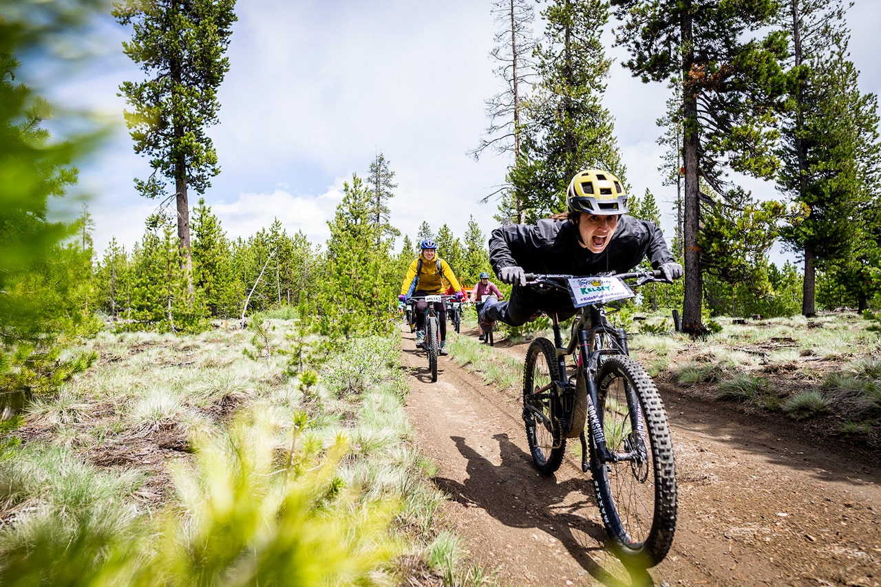 Ladies AllRide flying down a dirt trail in Bend