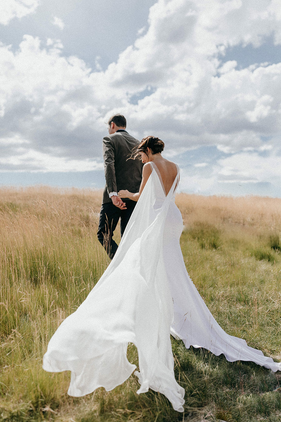 Couple walking away in field