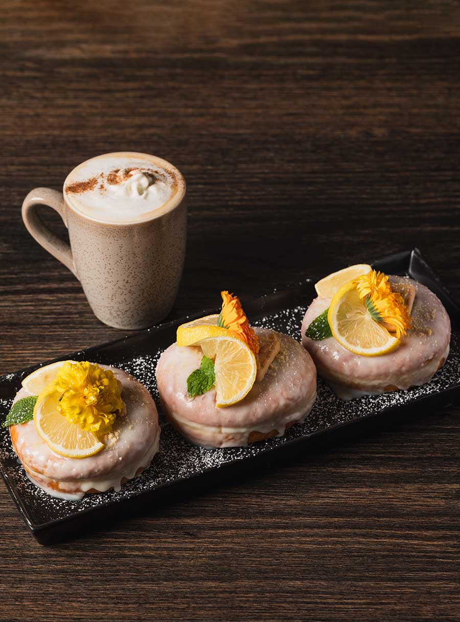 macaroons on a plate with a hot beverage from Brand44