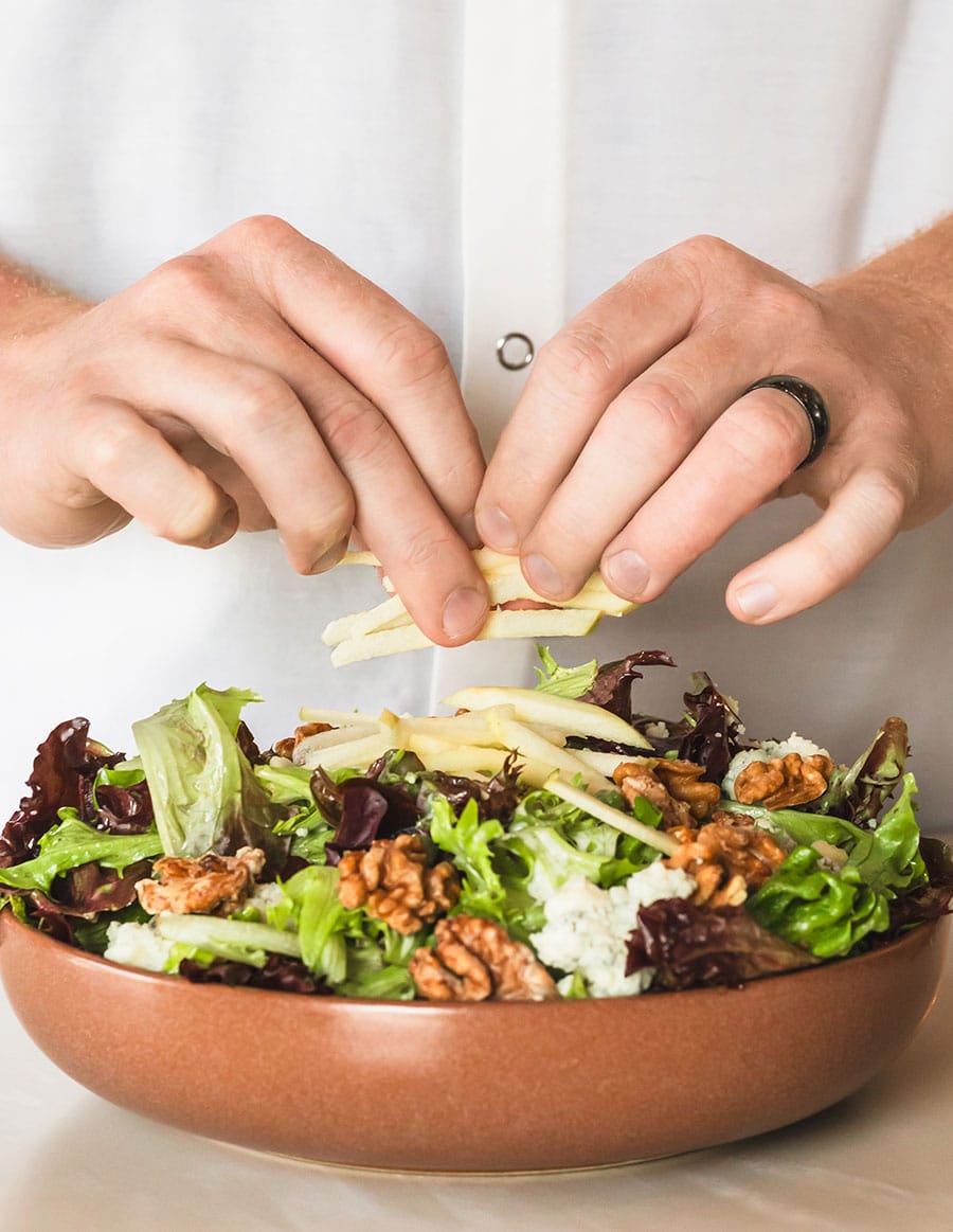 Adding final touches to a fresh salad