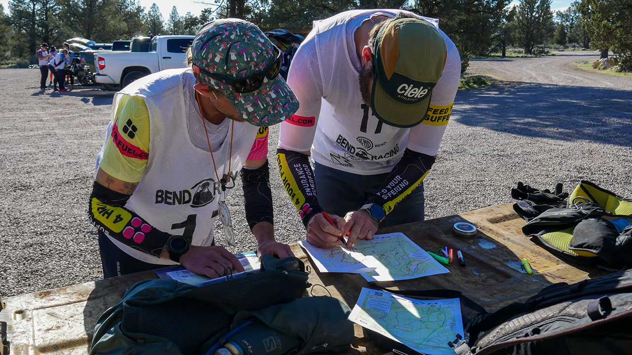 Adventure racers reviewing the maps pre race