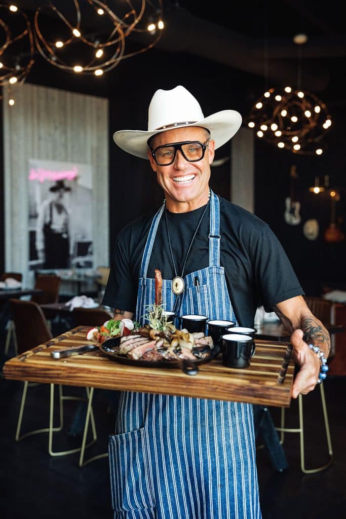 Brian Malarkey posing with steak dish