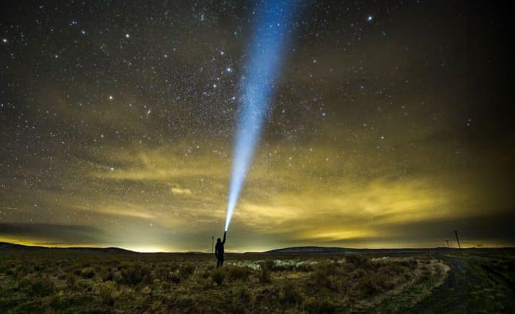 Shining a light up to the sky at night