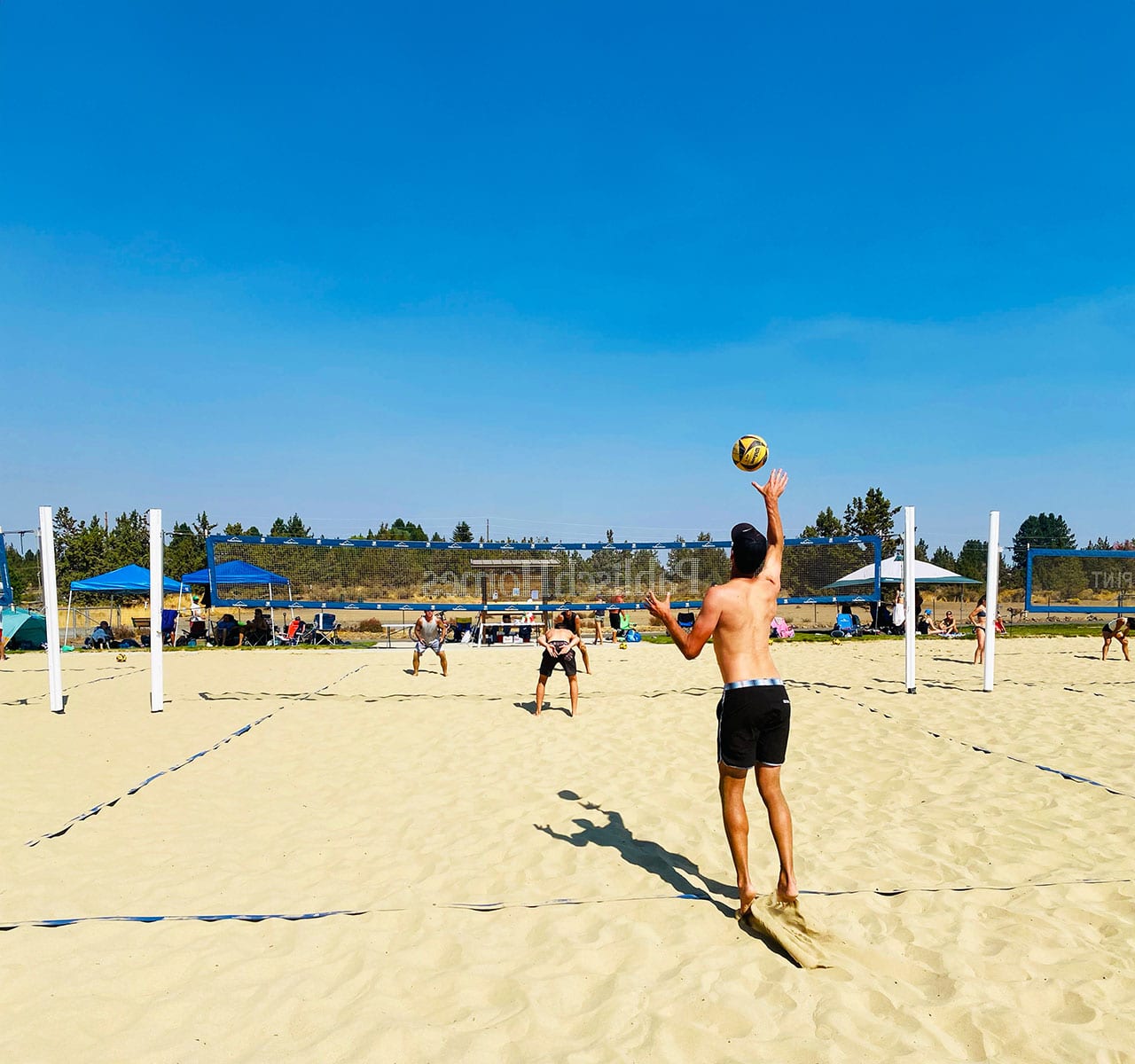 Volleyball player hitting the ball over the net