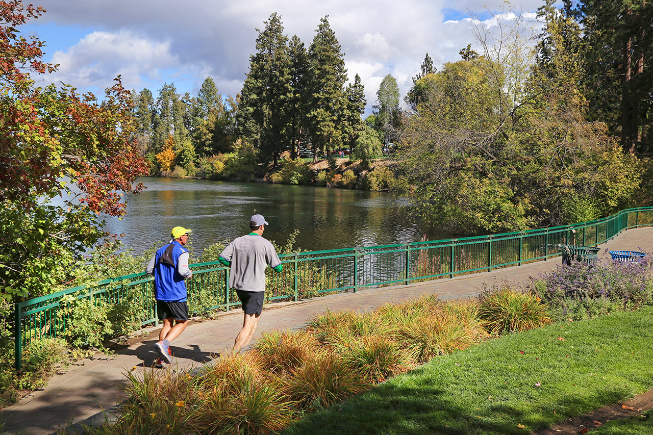 two men running Drake Park downtown Bend Oregon