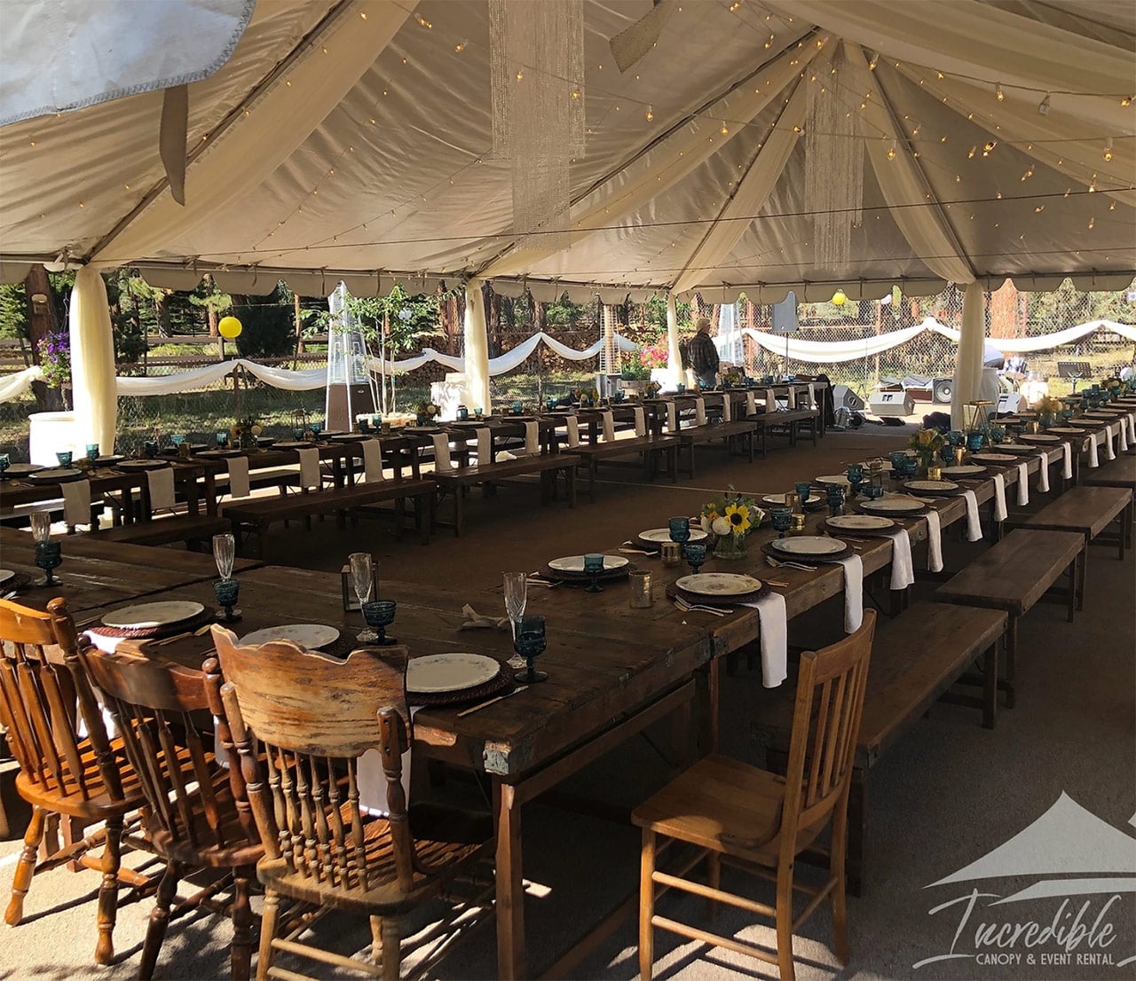 event table under wedding tent by incredible events central oregon