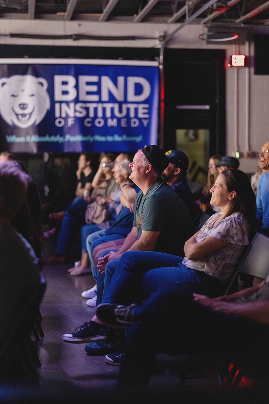 Audience enjoying a show laughing.