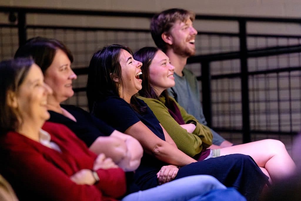 People laughing in auditorium