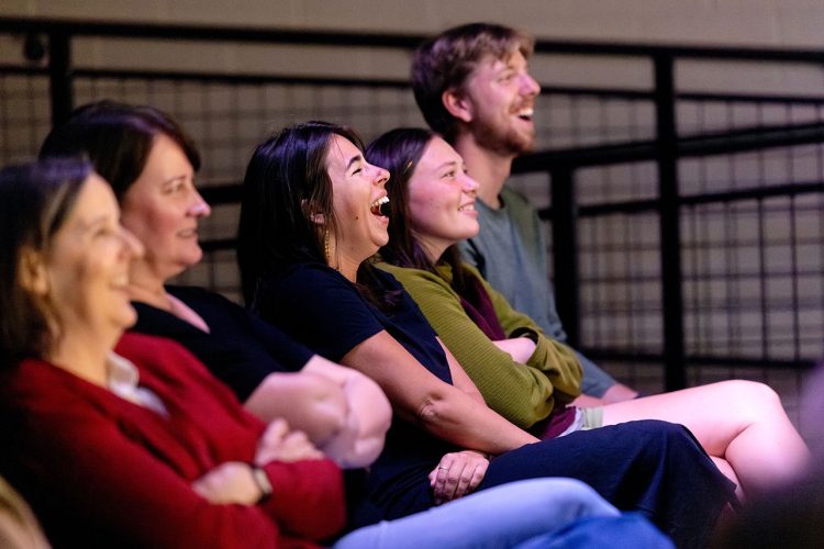 People laughing in auditorium