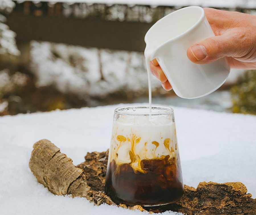 Cream poured into a cocktail in the snow.