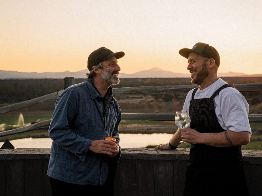 Chef Karl Holl and Scott Baird at sunset at Wild Rye Restaurant