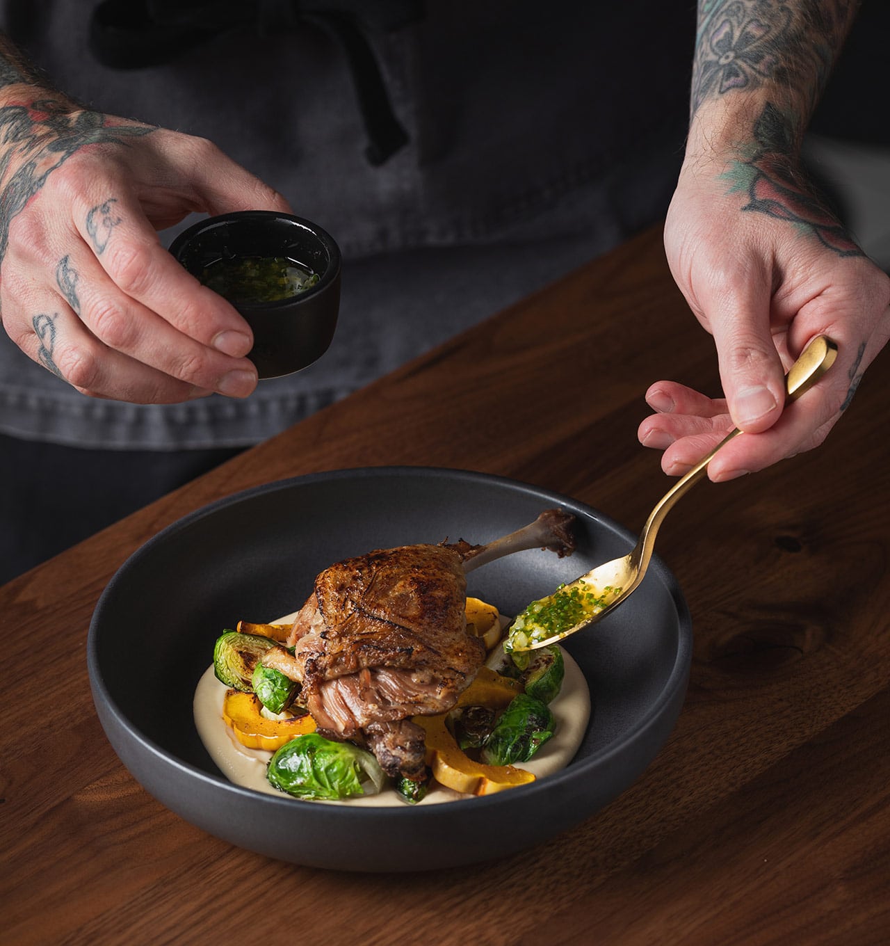 Chef Jonny Becklund finishing dish at Dear Irene