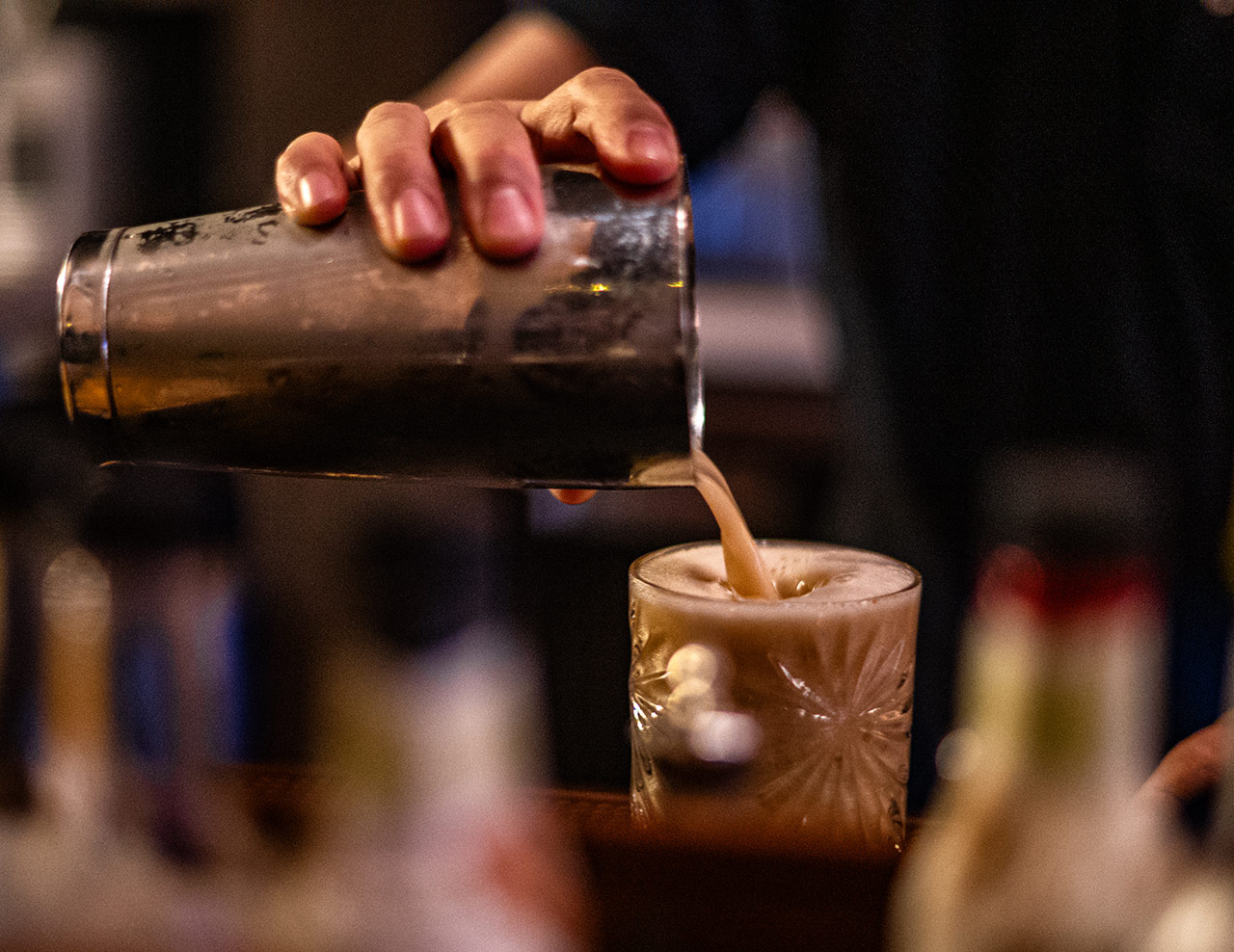 Bartender pouring a Naughty & Nice Cocktail at Bar Rio